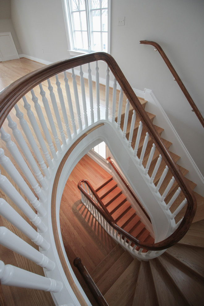 Staircase - huge traditional wooden u-shaped wood railing staircase idea in DC Metro with wooden risers
