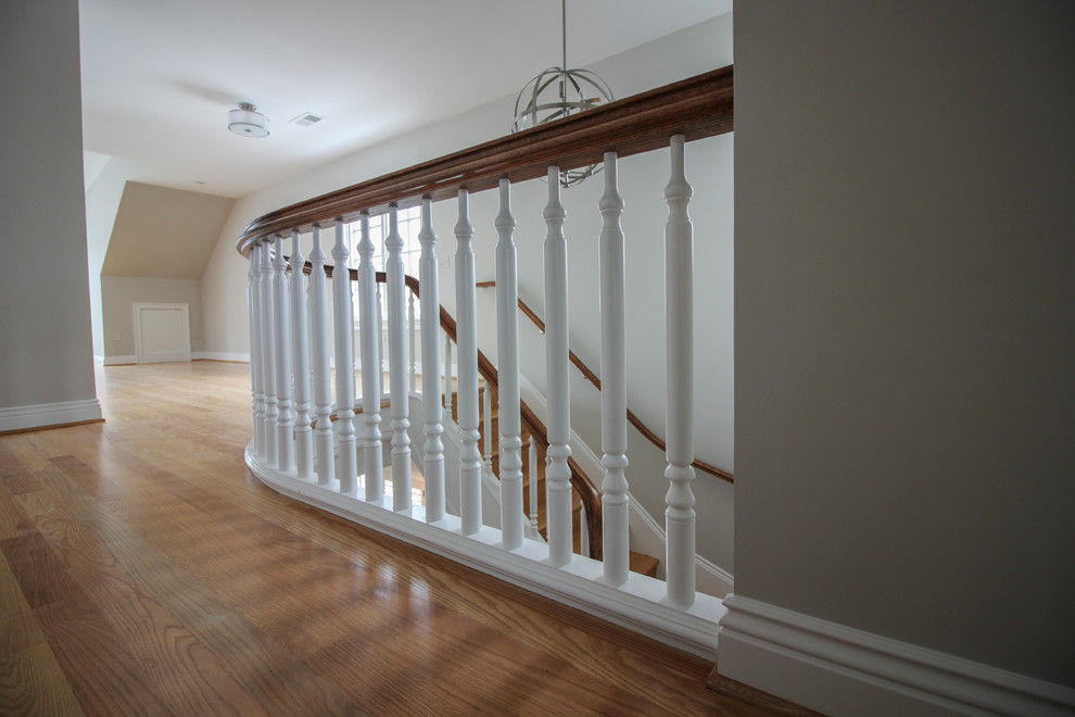 Staircase - huge traditional wooden u-shaped wood railing staircase idea in DC Metro with wooden risers