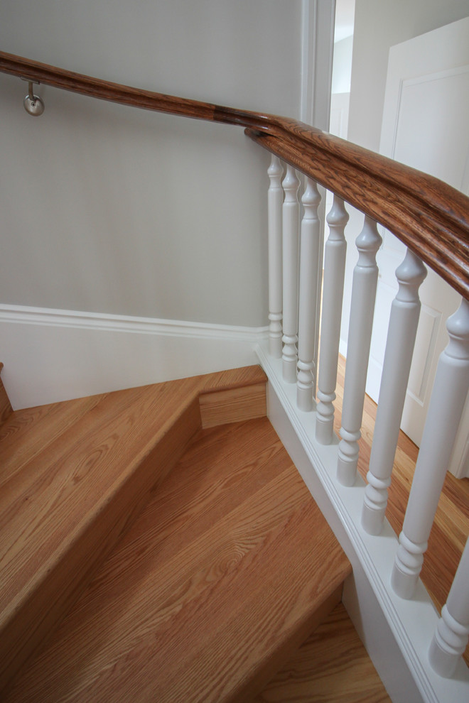 Design ideas for an expansive classic wood u-shaped wood railing staircase in DC Metro with wood risers.