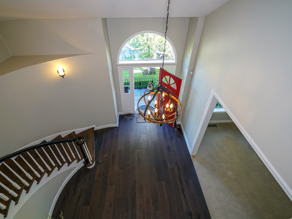 Photo of a large traditional wood curved wood railing staircase in San Francisco with wood risers.
