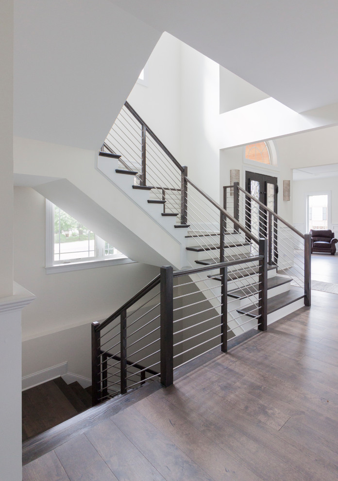 Example of a large transitional wooden u-shaped mixed material railing staircase design in DC Metro with wooden risers
