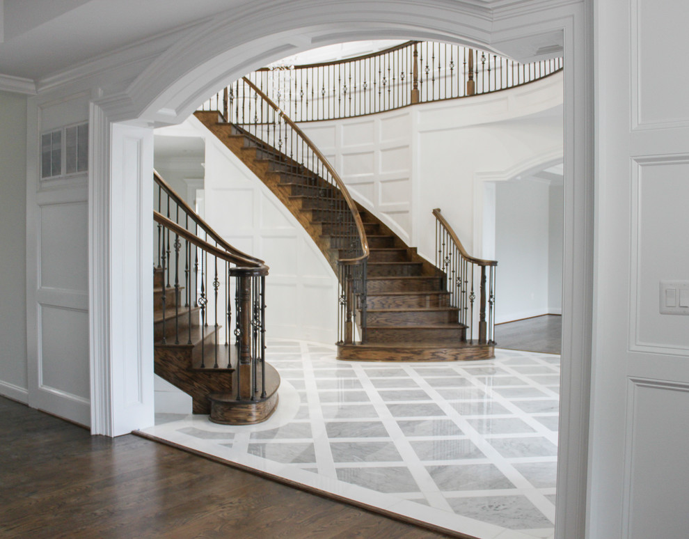 Источник вдохновения для домашнего уюта: большая изогнутая деревянная лестница в современном стиле с деревянными ступенями и перилами из смешанных материалов
