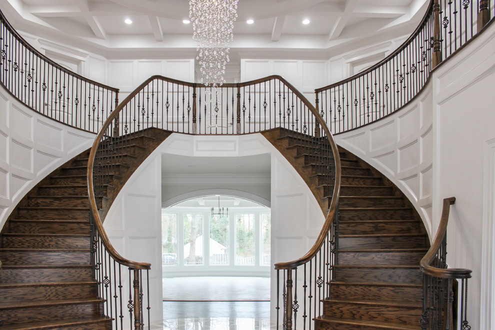 Example of a large trendy wooden curved mixed material railing staircase design in DC Metro with wooden risers