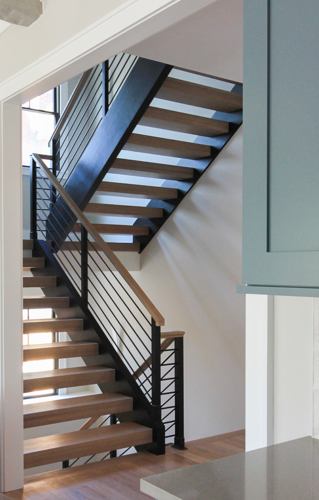 Idées déco pour un grand escalier flottant moderne avec des marches en bois et un garde-corps en matériaux mixtes.
