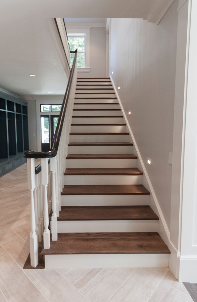 Example of a large cottage chic wooden straight wood railing staircase design in DC Metro with wooden risers