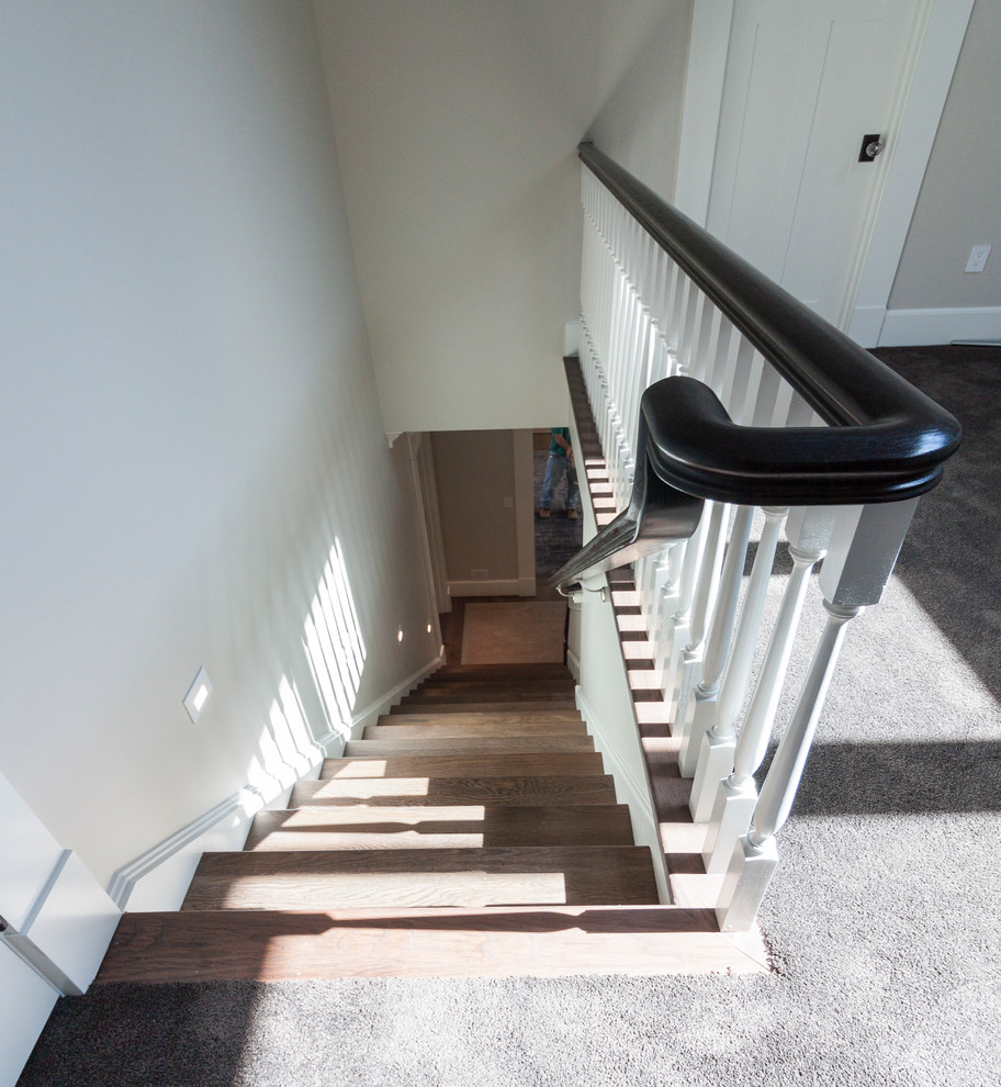 Large shabby-chic style wood straight wood railing staircase in DC Metro with wood risers.