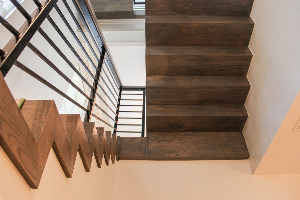 Large eclectic wooden floating metal railing staircase photo in DC Metro with wooden risers