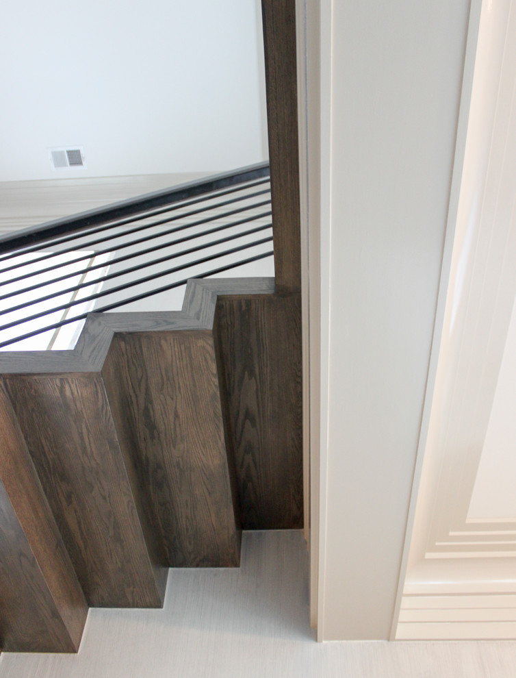 Inspiration for a large eclectic wooden floating metal railing staircase remodel in DC Metro with wooden risers