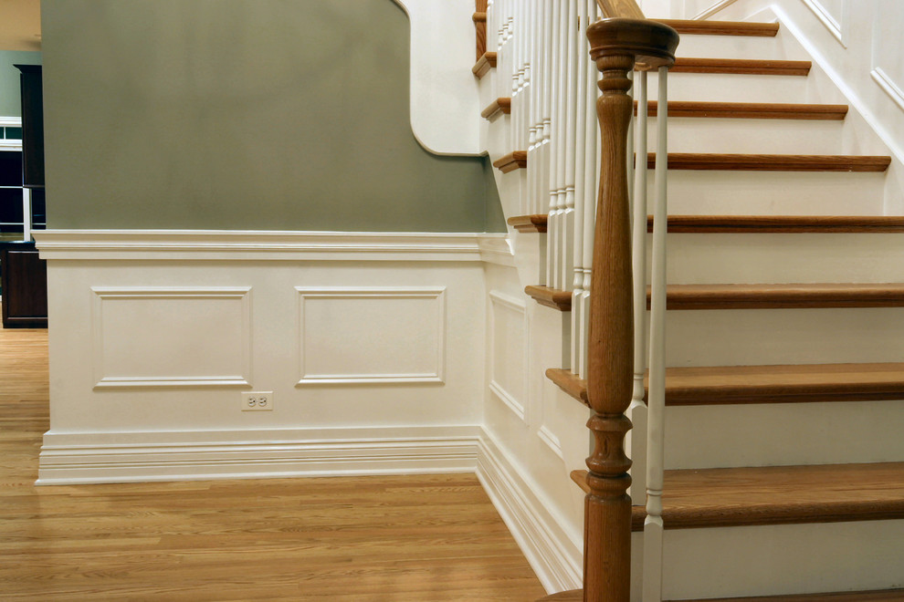 This is an example of a medium sized classic wood straight staircase in Chicago.