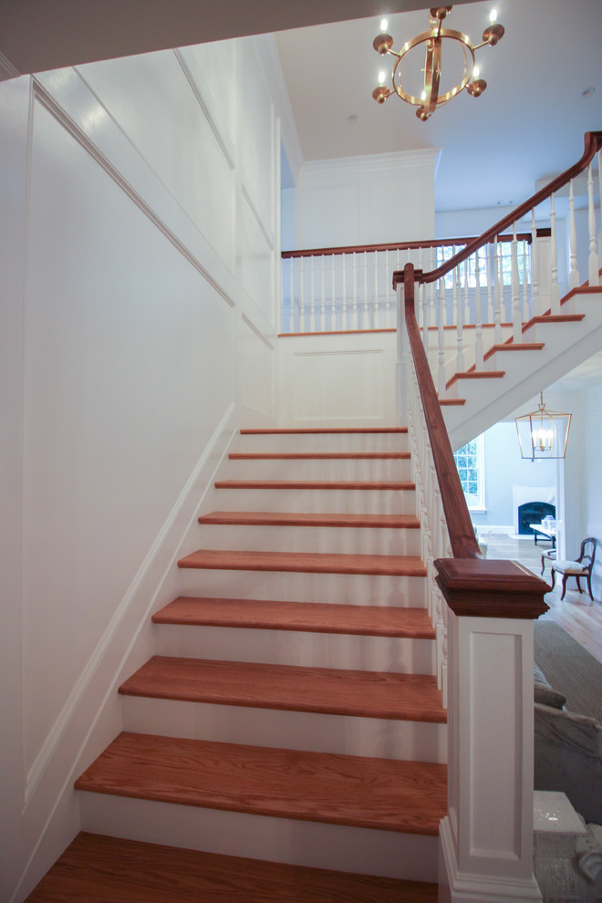 Example of a mid-sized arts and crafts wooden u-shaped wood railing staircase design in DC Metro with wooden risers