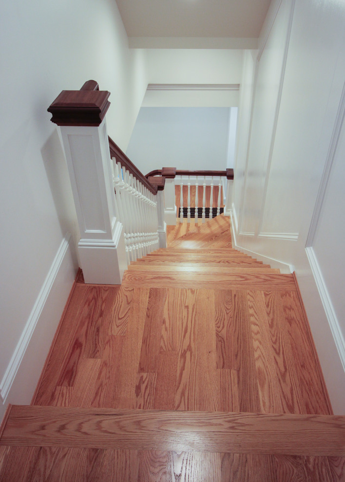 Design ideas for a medium sized classic wood u-shaped wood railing staircase in DC Metro with wood risers.