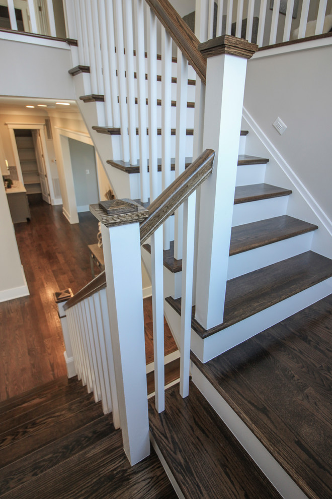 Aménagement d'un escalier moderne en U de taille moyenne avec des marches en travertin, des contremarches en bois et un garde-corps en bois.