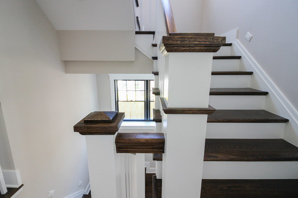 Diseño de escalera en U moderna de tamaño medio con escalones de travertino, contrahuellas de madera y barandilla de madera