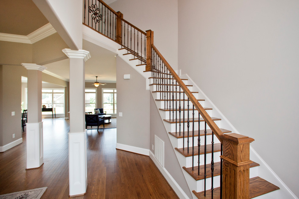 Inspiration for a large timeless wooden l-shaped staircase remodel in Raleigh with wooden risers