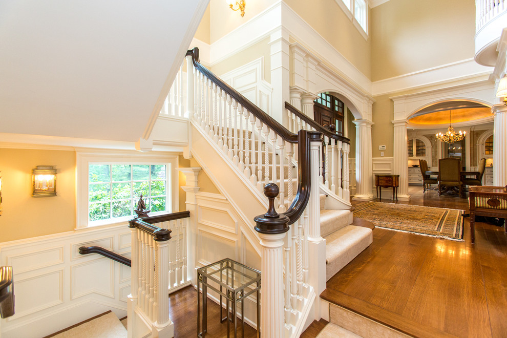 This is an example of a classic carpeted l-shaped staircase in Boston with carpeted risers.