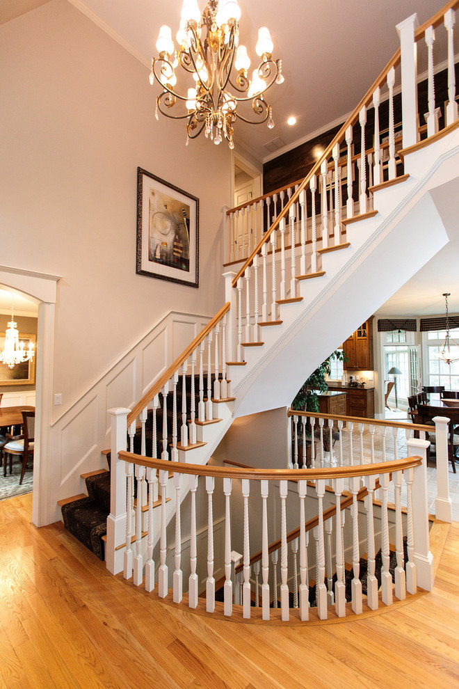 Staircase - huge traditional carpeted spiral wood railing staircase idea in Boston with carpeted risers