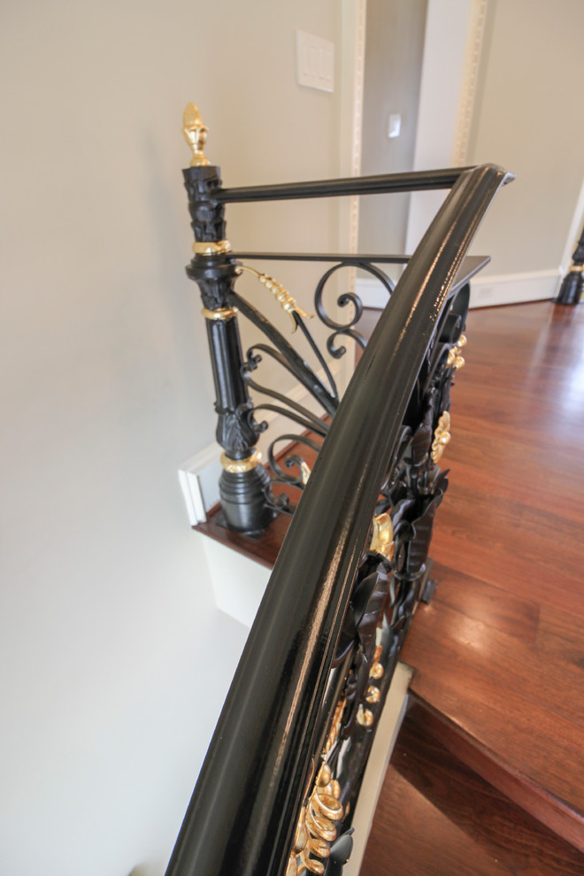 Modelo de escalera curva tradicional extra grande con escalones de madera, contrahuellas de madera y barandilla de metal