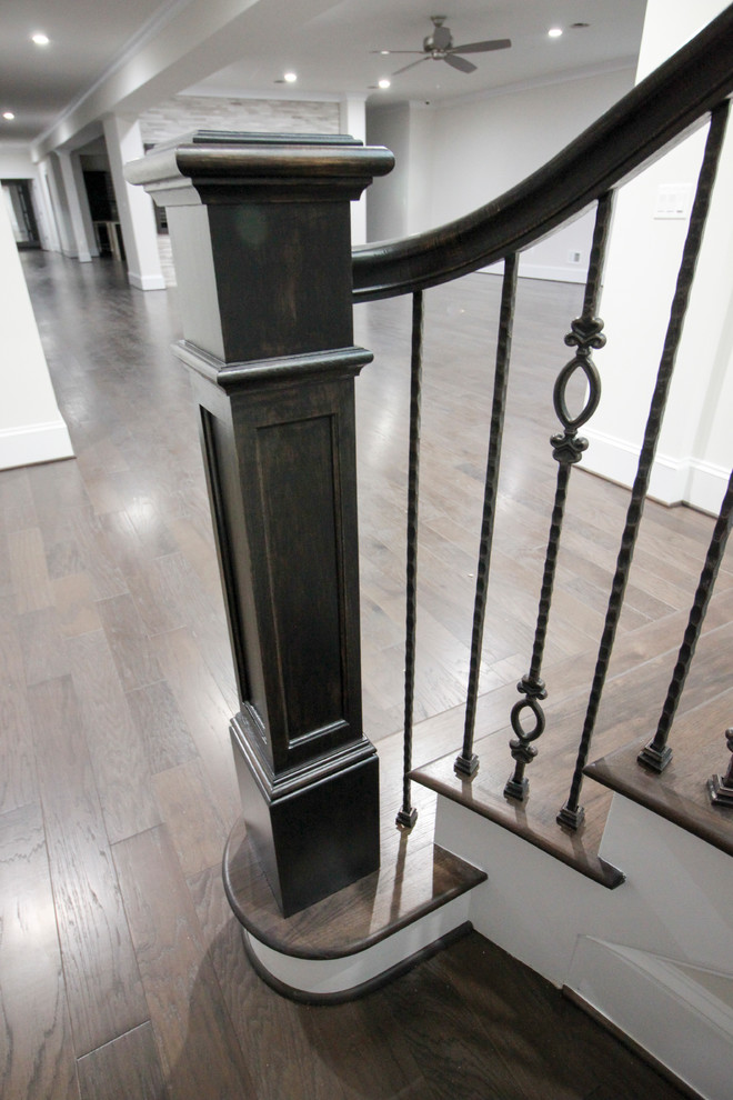 This is an example of a large classic wood floating glass railing staircase in DC Metro with wood risers.