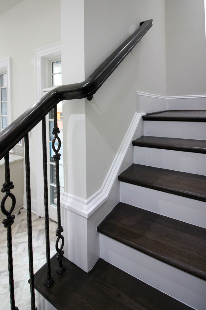 Large transitional wooden floating glass railing staircase photo in DC Metro with wooden risers