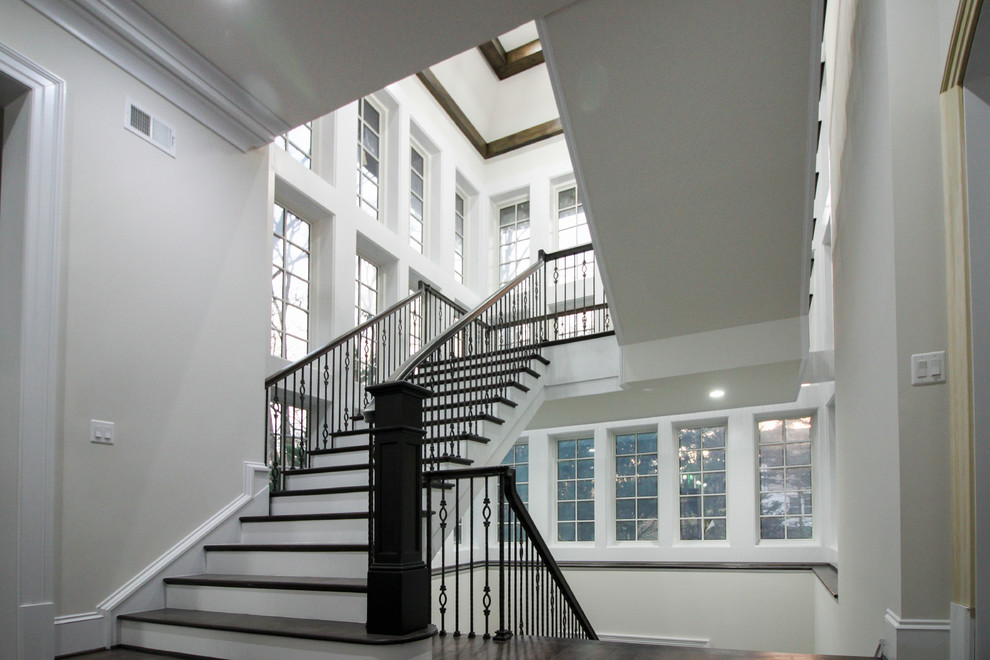 ワシントンD.C.にある高級な広いトランジショナルスタイルのおしゃれなスケルトン階段 (木の蹴込み板、ガラスフェンス) の写真