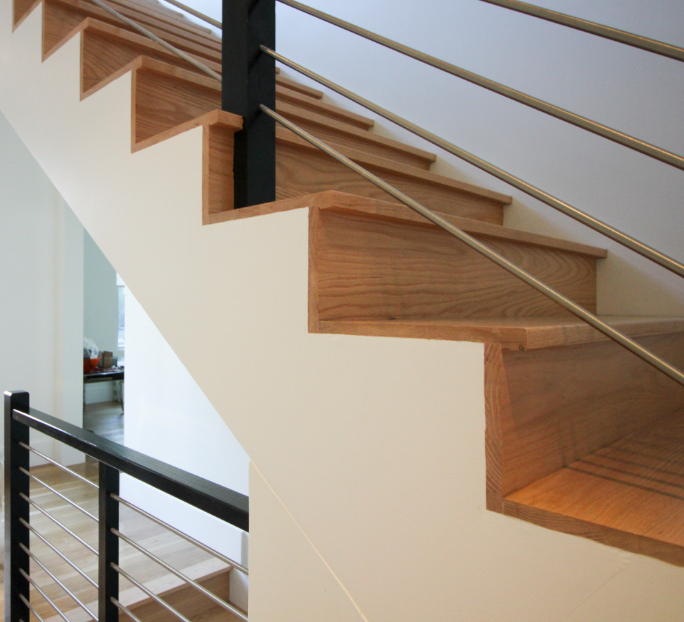 Large trendy wooden spiral mixed material railing staircase photo in DC Metro with wooden risers