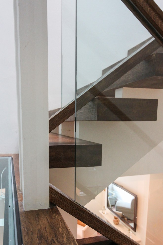 Источник вдохновения для домашнего уюта: огромная лестница на больцах в современном стиле с стеклянными ступенями и стеклянными перилами без подступенок