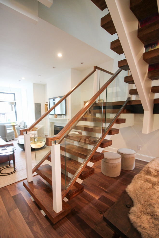 Expansive contemporary glass floating glass railing staircase in DC Metro with open risers.