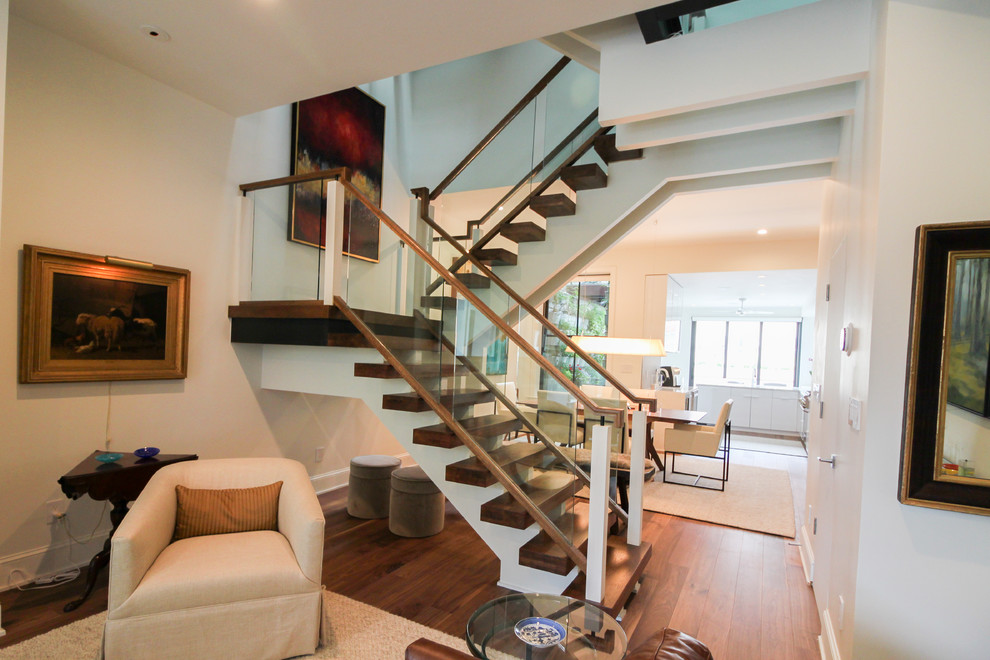 Imagen de escalera suspendida contemporánea extra grande sin contrahuella con escalones de vidrio y barandilla de vidrio