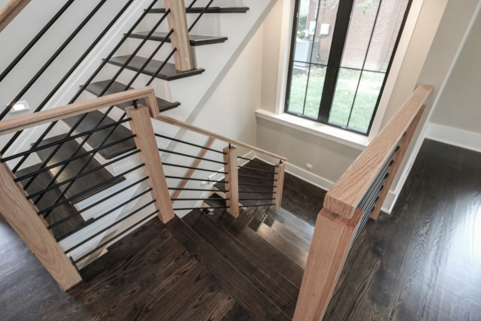 Photo of a medium sized bohemian wood u-shaped mixed railing staircase in DC Metro with wood risers.