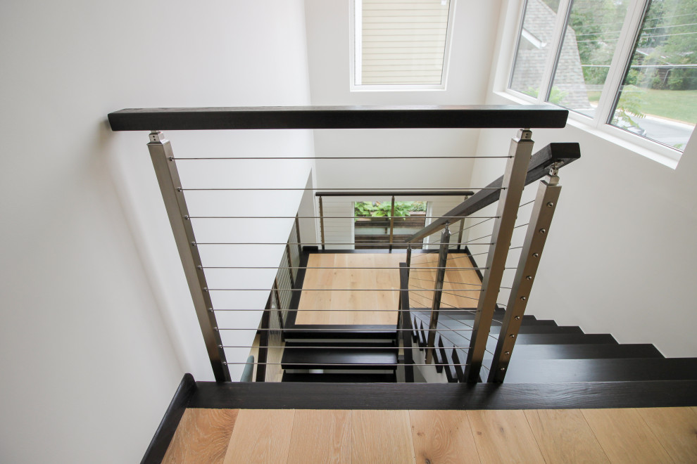 Inspiration for a large contemporary wood u-shaped mixed railing staircase in DC Metro.
