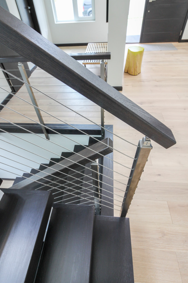 Modelo de escalera en U actual grande con escalones de madera y barandilla de varios materiales