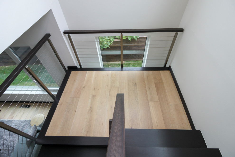 Design ideas for a large contemporary wood u-shaped mixed railing staircase in DC Metro.