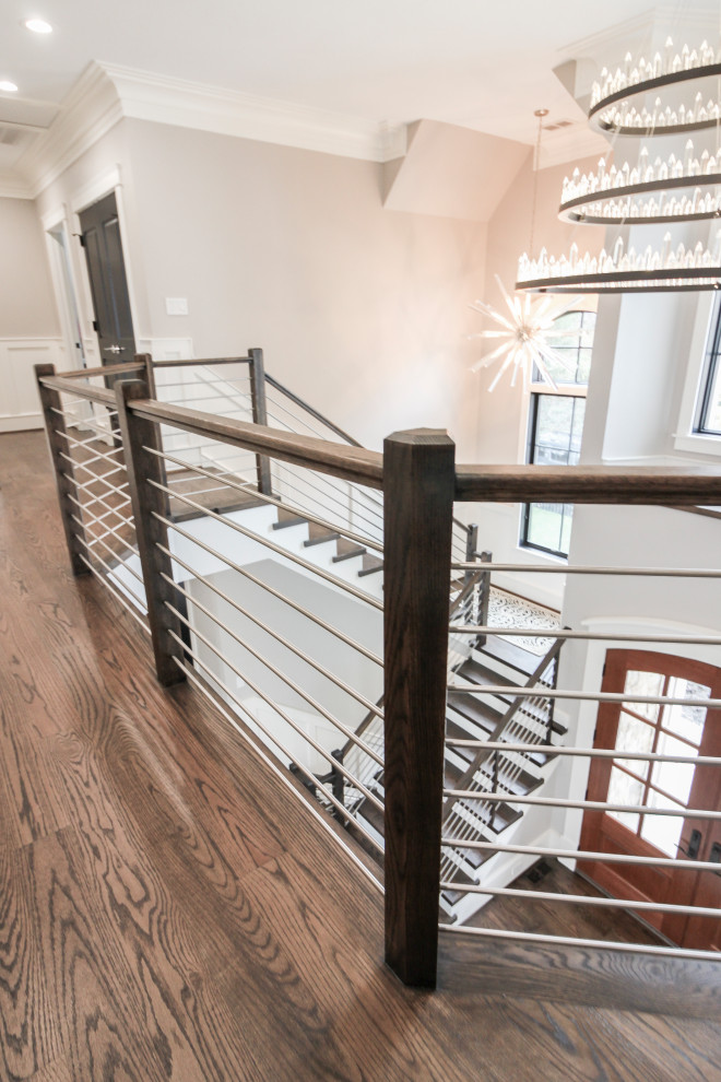 Ejemplo de escalera en U contemporánea grande con escalones de madera, contrahuellas de madera y barandilla de varios materiales