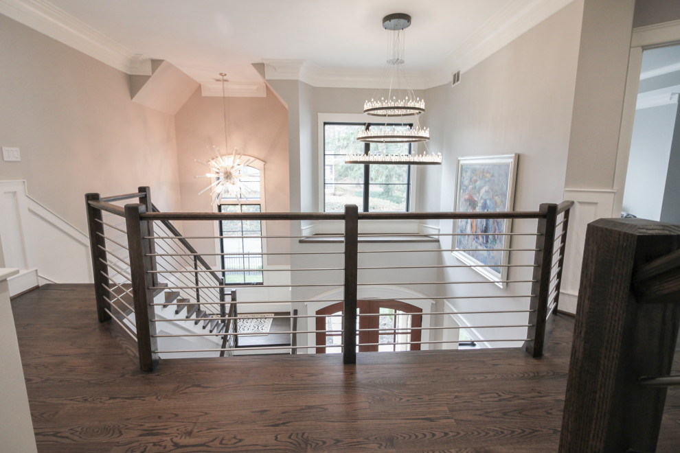 Ejemplo de escalera en U contemporánea grande con escalones de madera, contrahuellas de madera y barandilla de varios materiales