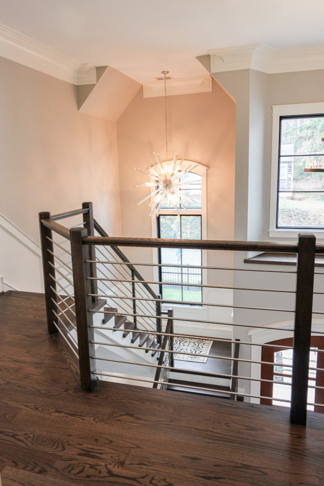 Large trendy wooden u-shaped mixed material railing staircase photo in DC Metro with wooden risers