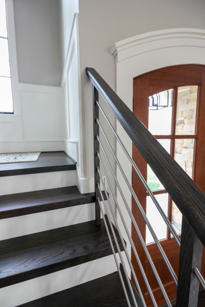 This is an example of a large contemporary wood u-shaped mixed railing staircase in DC Metro with wood risers.