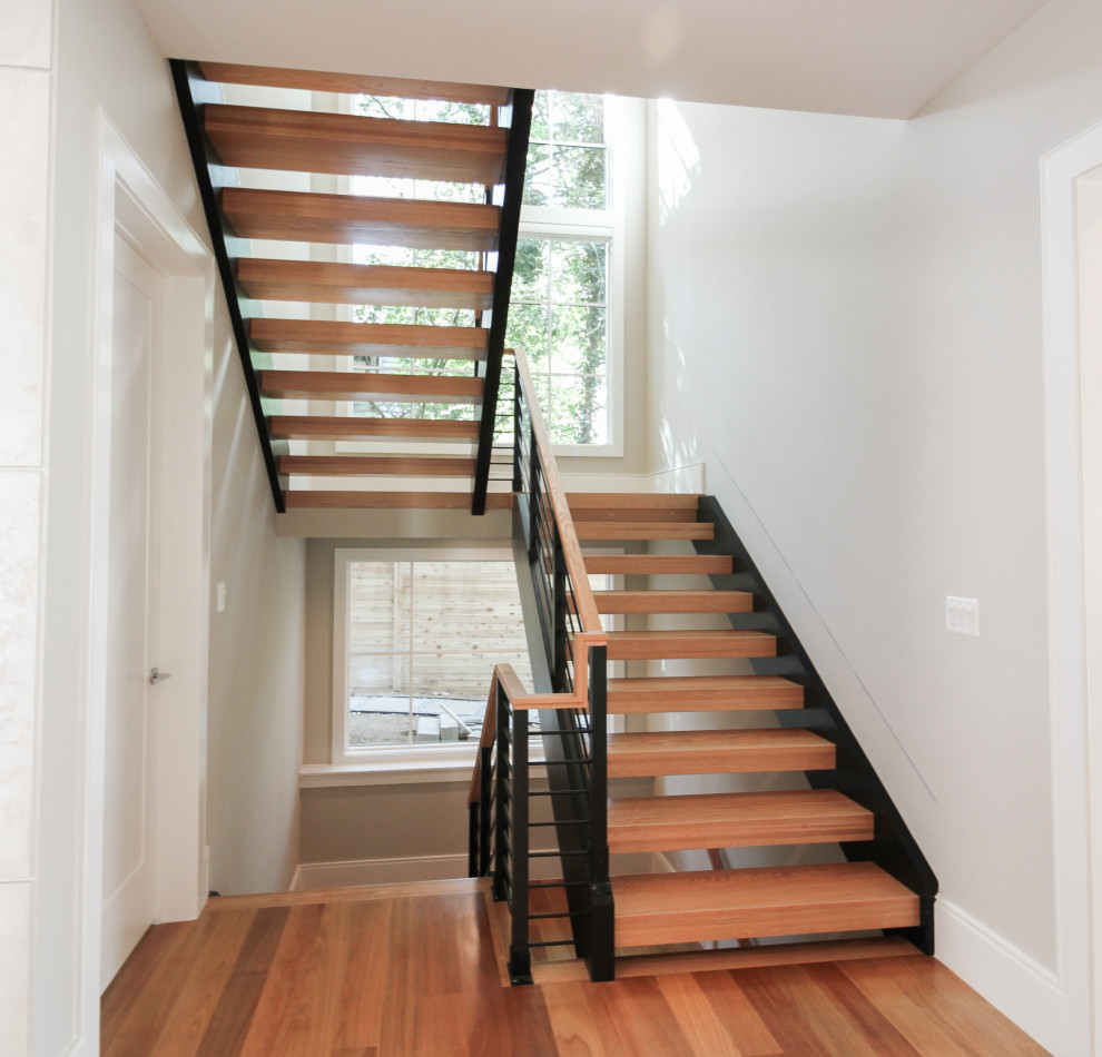 Inspiration for a large contemporary wood u-shaped mixed railing staircase in DC Metro.