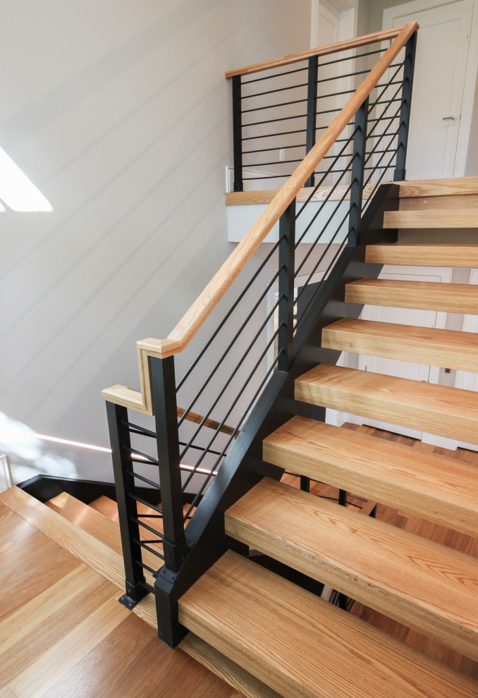 This is an example of a large contemporary wood u-shaped mixed railing staircase in DC Metro.