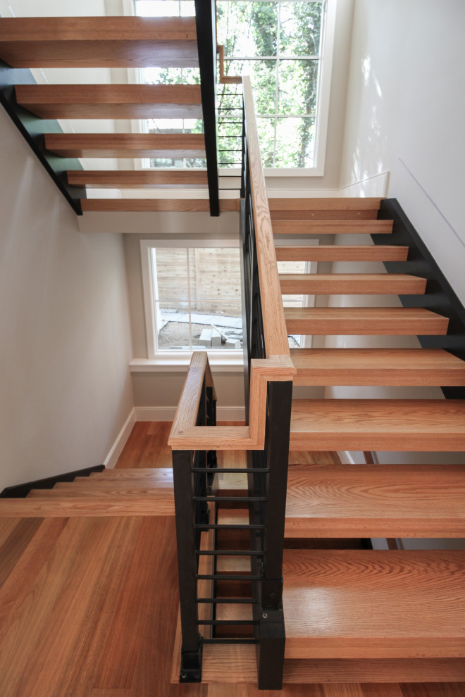 Foto de escalera en U contemporánea grande con escalones de madera y barandilla de varios materiales