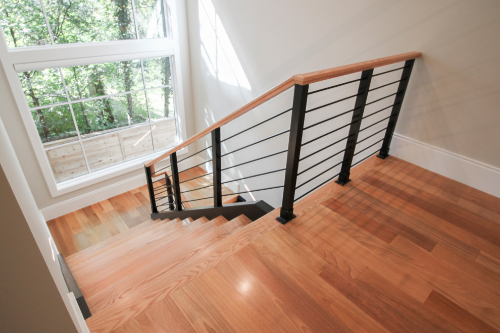 Modelo de escalera en U actual grande con escalones de madera y barandilla de varios materiales
