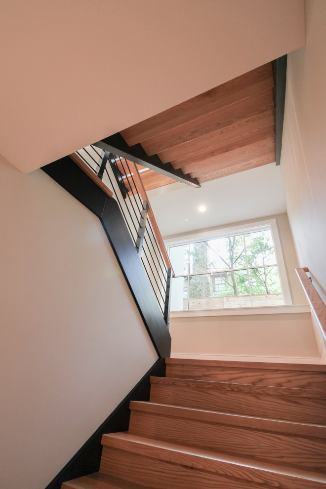 Ejemplo de escalera en U contemporánea grande con escalones de madera y barandilla de varios materiales