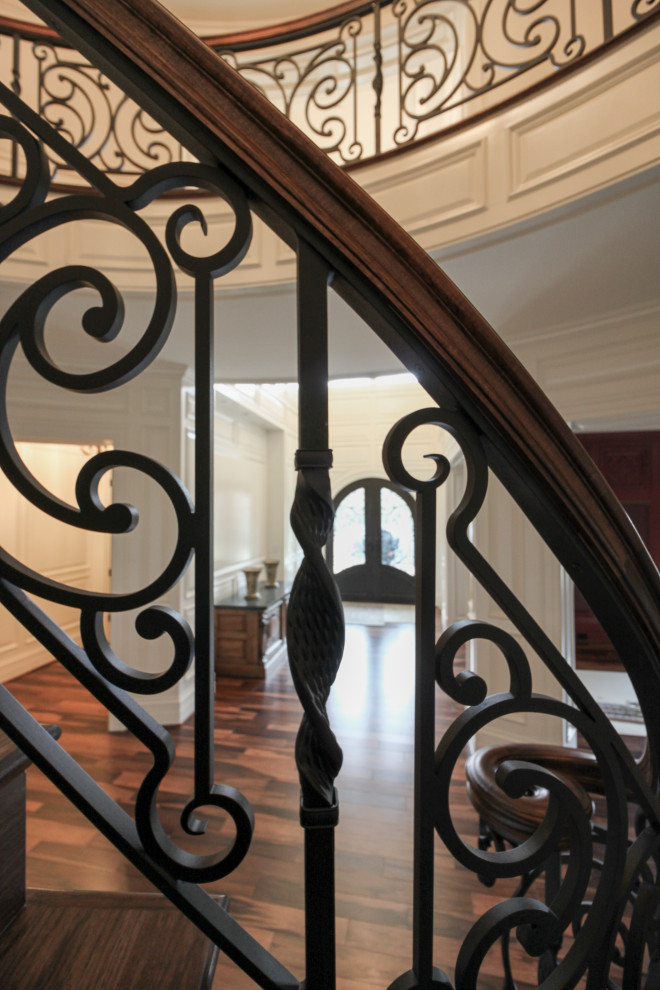 This is an example of a large bohemian wood curved mixed railing staircase in DC Metro with wood risers.