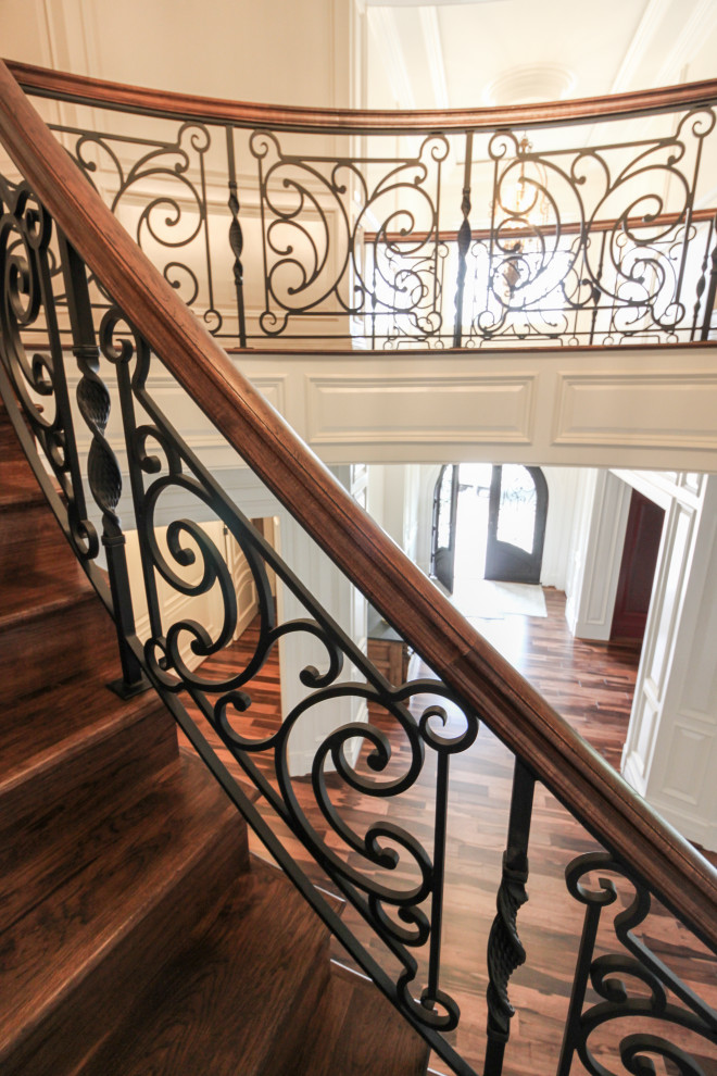Large bohemian wood curved mixed railing staircase in DC Metro with wood risers.