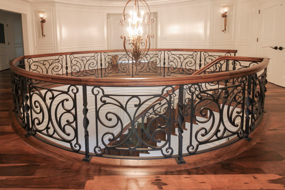 Large eclectic wood curved mixed railing staircase in DC Metro with wood risers.