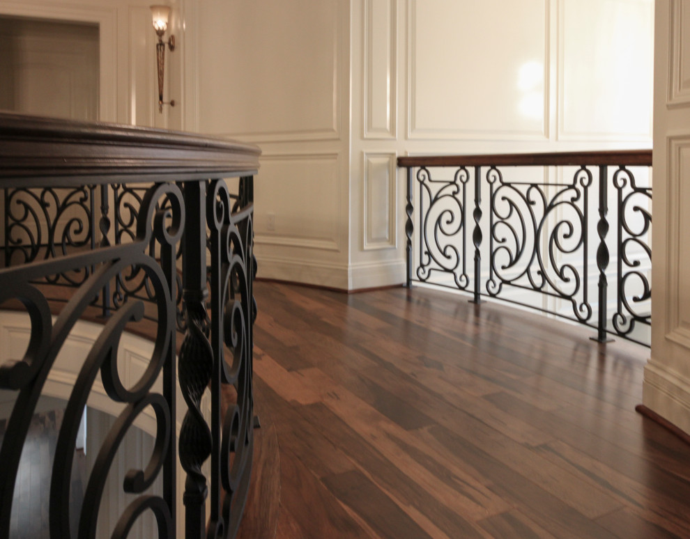 Photo of a large eclectic wood curved mixed railing staircase in DC Metro with wood risers.