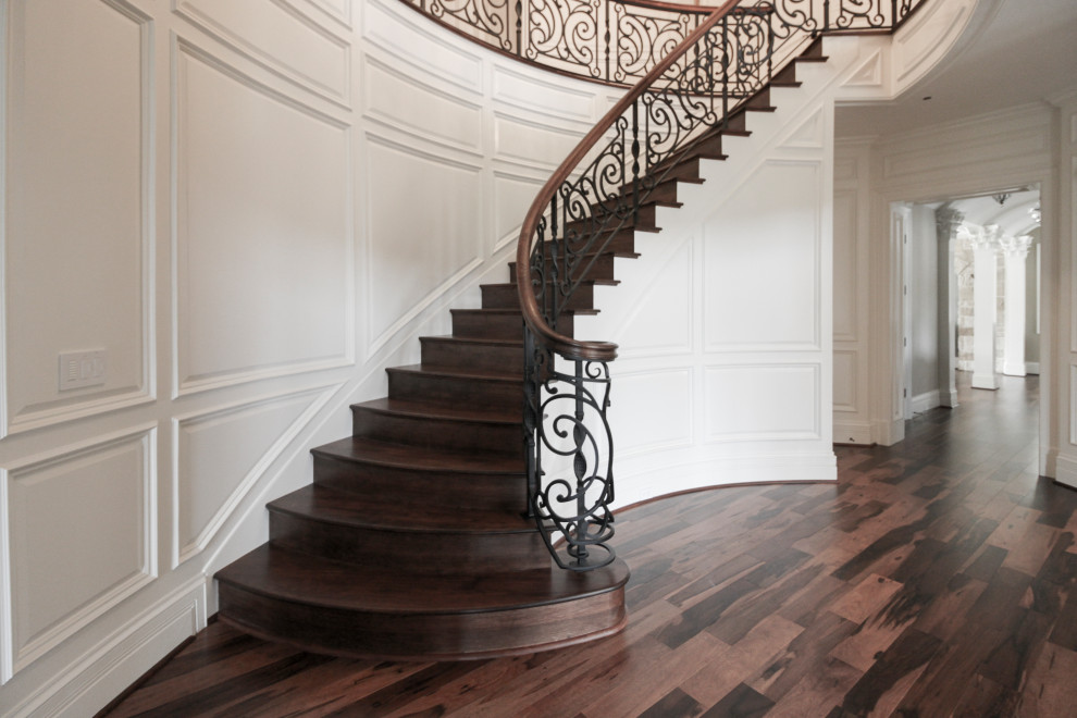 Example of a large eclectic wooden curved mixed material railing staircase design in DC Metro with wooden risers