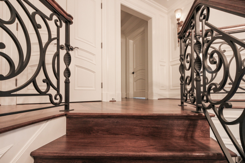 This is an example of a large eclectic wood curved mixed railing staircase in DC Metro with wood risers.