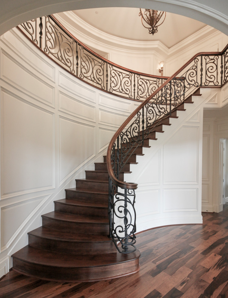 Inspiration for a large eclectic wood curved mixed railing staircase in DC Metro with wood risers.