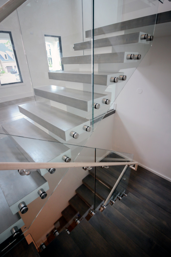Design ideas for an expansive modern wood floating glass railing staircase in DC Metro.
