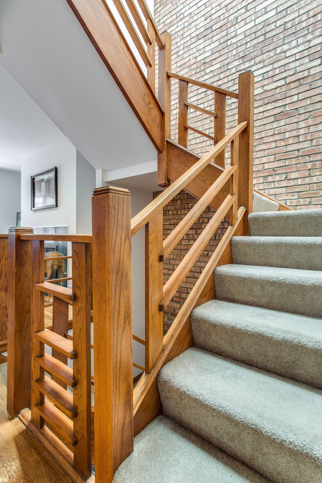 Design ideas for a contemporary carpeted staircase in Chicago with carpeted risers.